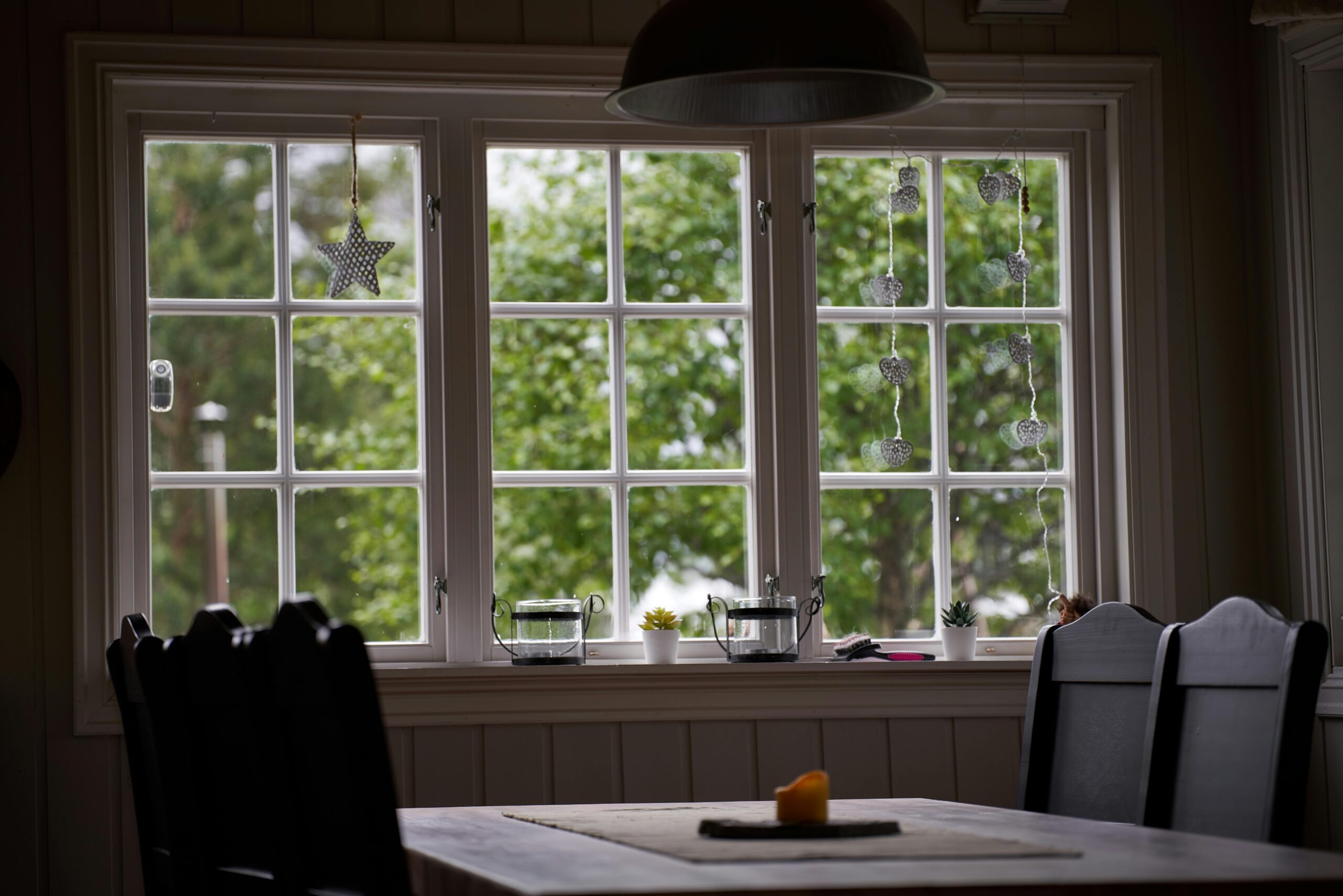 Inviting dining area featuring rustic chairs and a scenic window view in Krøderen, Norway.